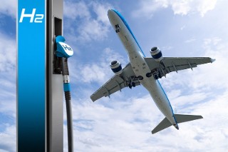 Hydrogen fuel nozzle with the inscription H2 on a background of airplane and blue sky.